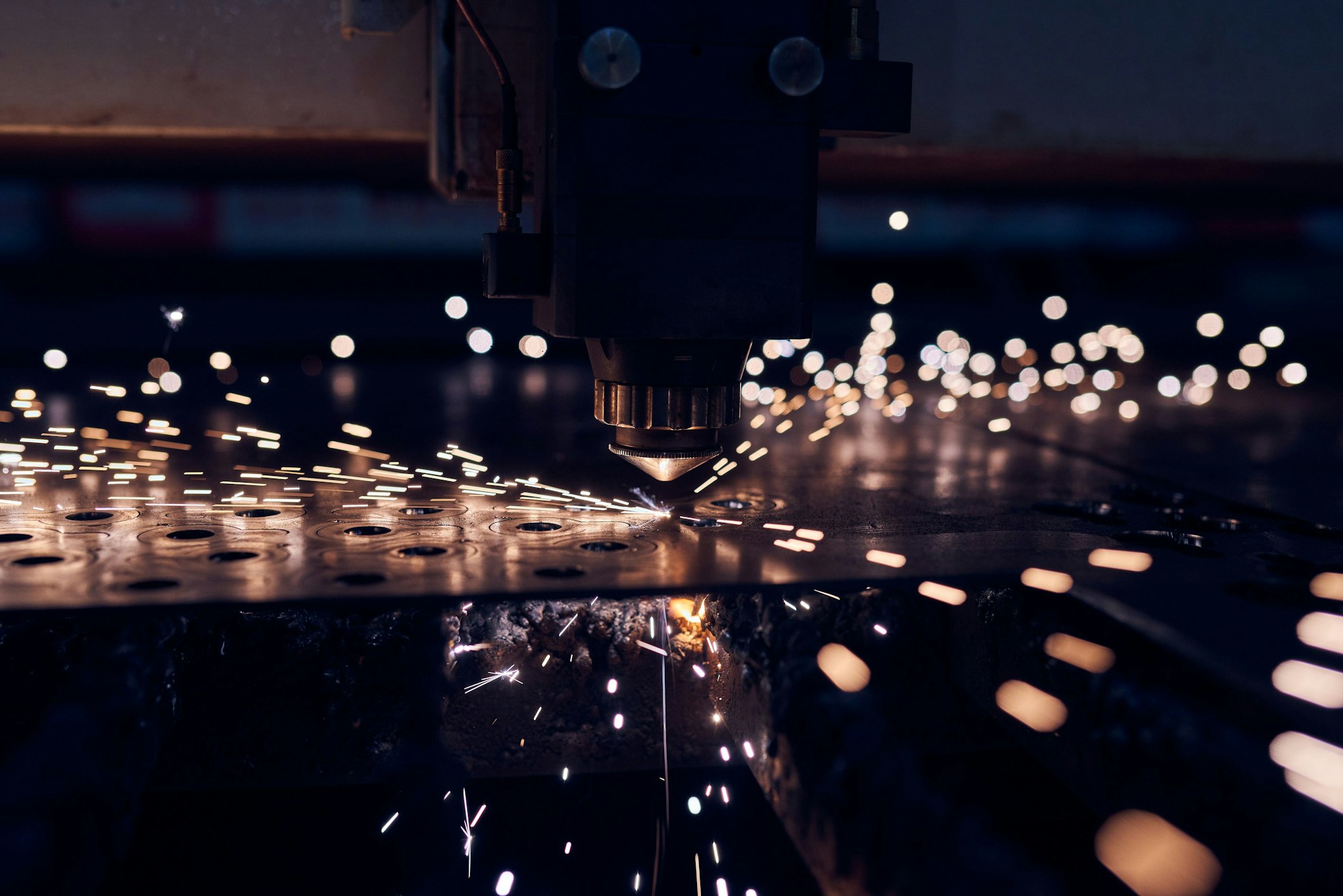 CNC Laser cutting of metal close up, modern industrial technology. Small depth of field