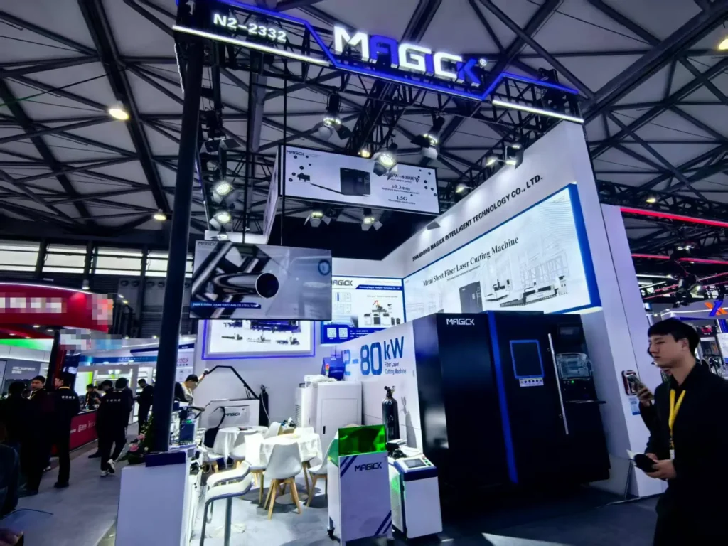 Panoramic view of Magick Laser booth N2-2332 at Photonics China 2026, with backlit displays highlighting the 12kW-80kW high-power fiber laser cutting machine series and MK-G series branding.