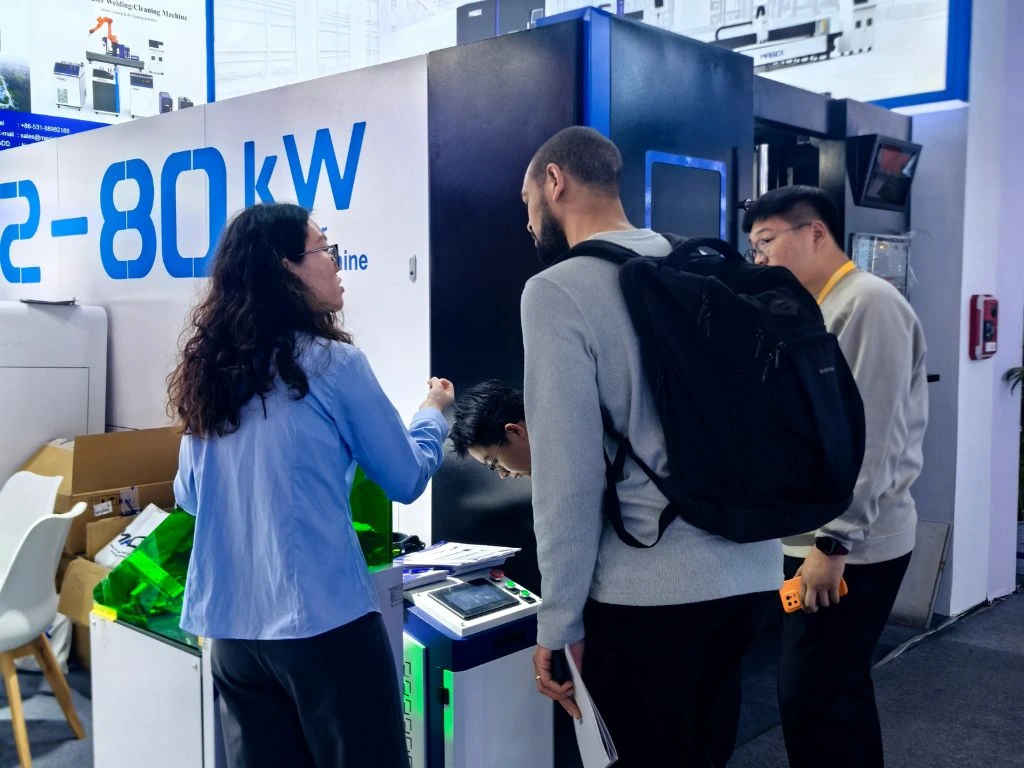 Magick Laser expert explaining the intelligent control panel of high-power fiber laser equipment to international buyers at Booth N2-2332.